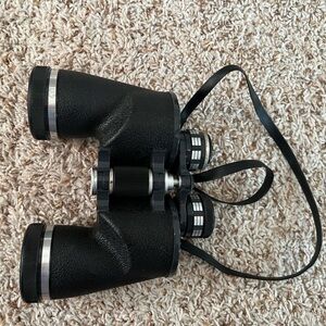Vintage pair of Jason Statesman Deluxe 7x50 binoculars with original strap.